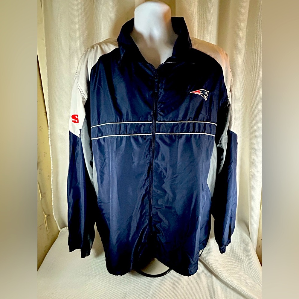 Dunbrooke patriot windbreaker SI on the sleeve, navy gray, and white and red